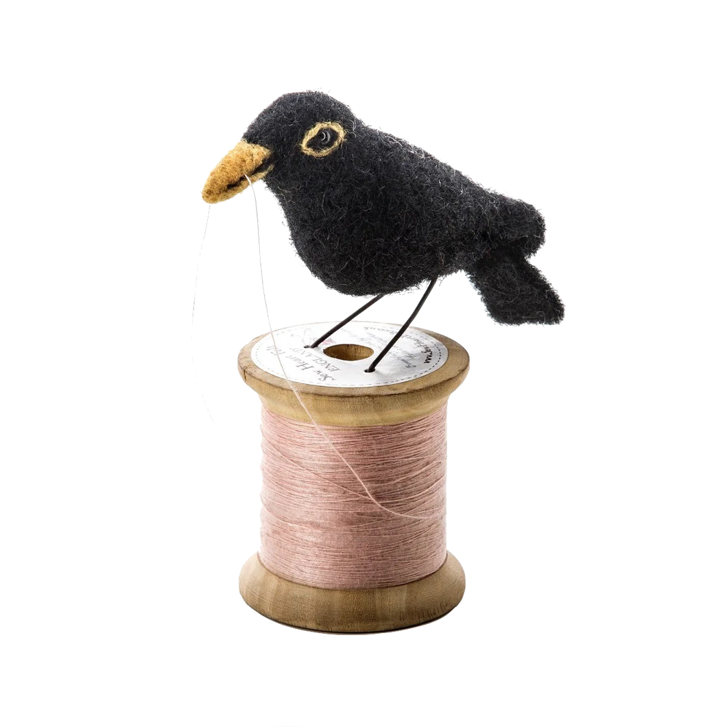 Blackbird on spool of thread