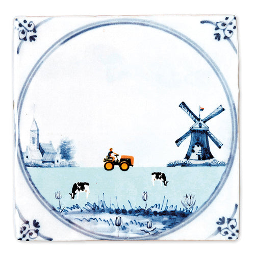 StoryTile Hollands Glorie. Op deze siertegel staat een Hollands plaatje: een molen, kerk, tractor en koeien in de wei. Ook staan er enkele tulpen op. Deze StoryTile heeft een Delfts Blauwe stijl